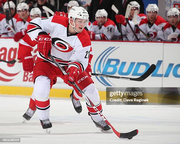 Drayson Bowman of the Carolina Hurricanes skates up ice with the puck against the Detroit Red Wings during an NHL game on April 11, 2014 at Joe Louis...