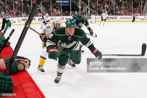 Cody McCormick of the Minnesota Wild and Craig Smith of the Nashville Predators skate to the puck during the game on April 13, 2014 at the Xcel...