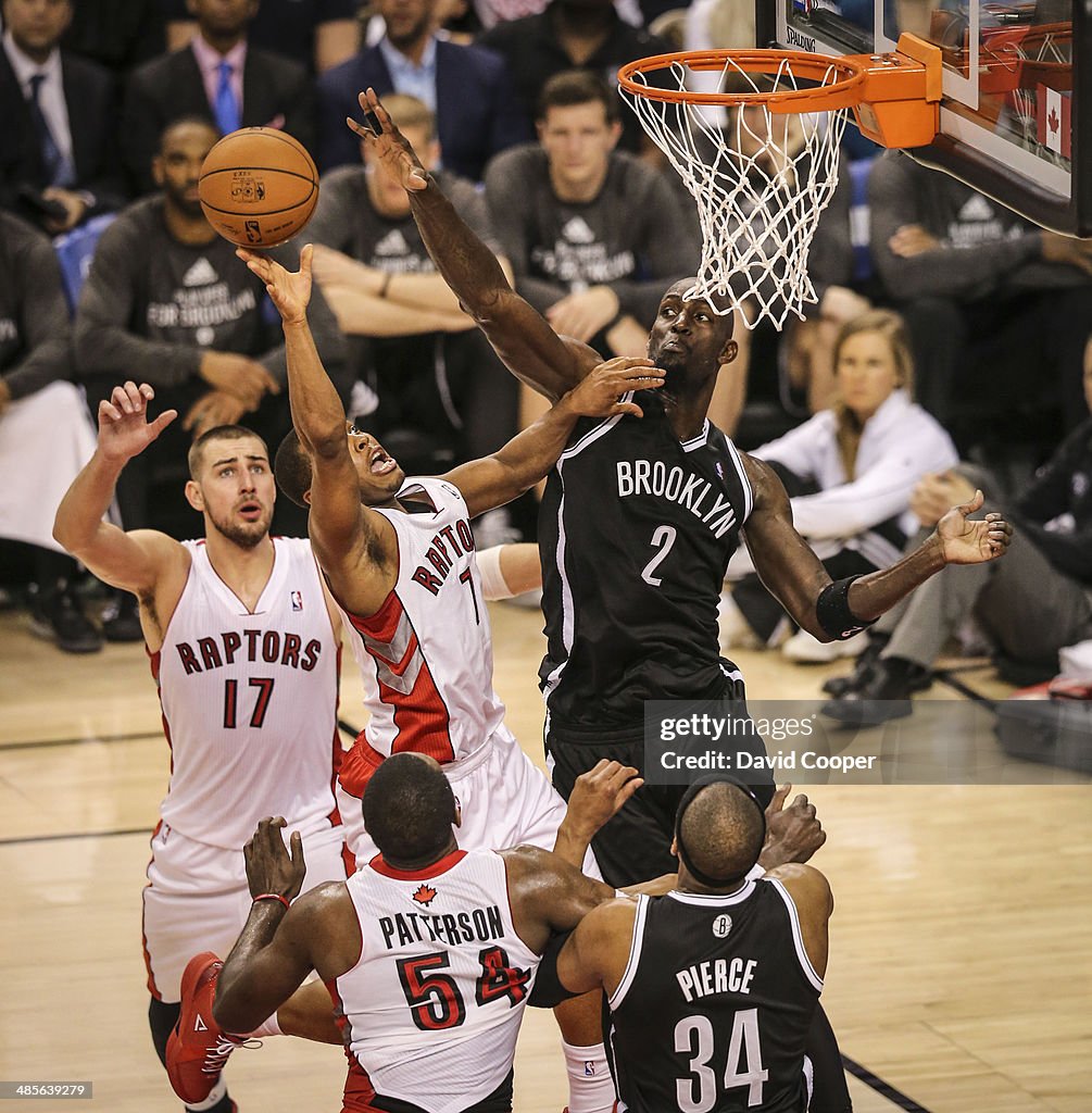 Toronto Raptors guard Kyle Lowry (7) battles under the hoop with Brooklyn Nets centre Kevin Garnett (2) but they couldn't get it done as the Nets won 94-87