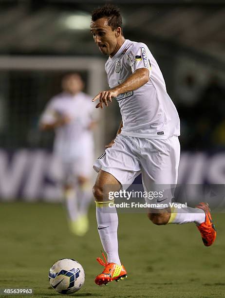 Thiago Ribeiro of Santos runs with the ball during the match between Santos and Mixto as part of Copa do Brasil 2014 at Vila Belmiro Stadium on April...