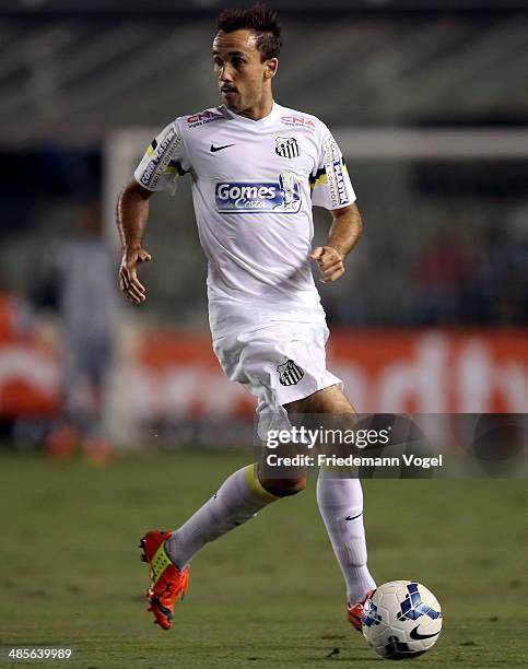 Thiago Ribeiro of Santos runs with the ball during the match between Santos and Mixto as part of Copa do Brasil 2014 at Vila Belmiro Stadium on April...