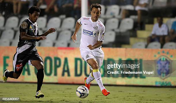 Denilson of Mixto fights for the ball with Thiago Ribeiro of Santos during the match between Santos and Mixto as part of Copa do Brasil 2014 at Vila...