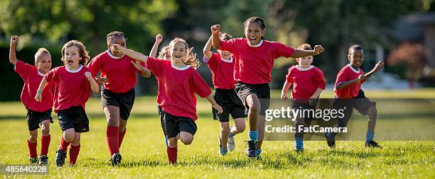 soccer players running and cheering - girl panoramic stock pictures, royalty-free photos & images