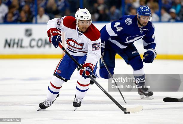 Francis Bouillon of the Montreal Canadiens brings the puck up the ice past Nate Thompson of the Tampa Bay Lightning in Game One of the First Round of...