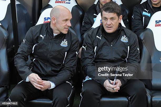 Newcastle Assistant Manager John Carver and First Team Coach Steve Stone sit in the dugout during the Barclays Premier League match between Newcastle...