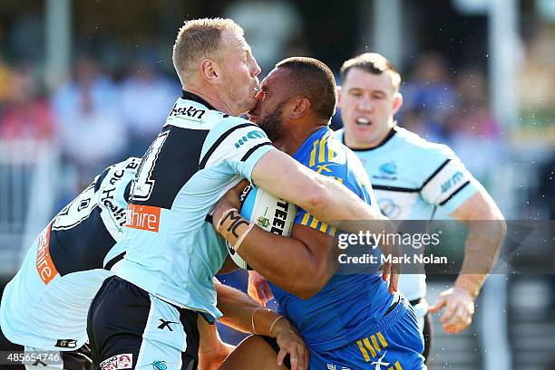 Luke Lewis of the Sharks and Junior Paulo of the Eels collide during the round 25 NRL match between the Parramatta Eels and the Cronulla Sharks at...