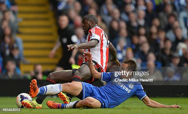 Cesar Azpilicueta of Chelsea fouls Jozy Altidore of Sunderland to give away a penalty during the Barclays Premier League match between Chelsea and...