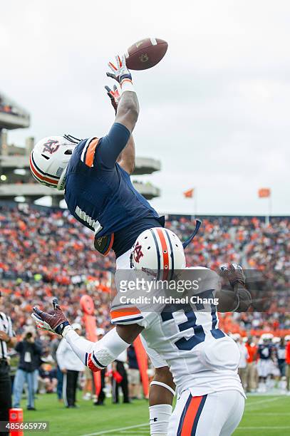 Wide receiver D'haquille Williams of the Auburn Tigers catches a pass for a touchdown in front of defensive back Kamryn Melton of the Auburn Tigers...