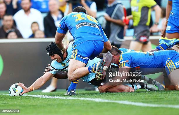 Michael Ennis of the Sharks scores the winning try during the round 25 NRL match between the Parramatta Eels and the Cronulla Sharks at Pirtek...
