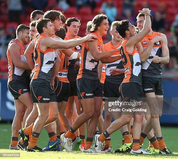 Giants team celebrate with Jeremy Cameron of the Giants after kicking his 7th goal during the round AFL match between the Greater Western Sydney...