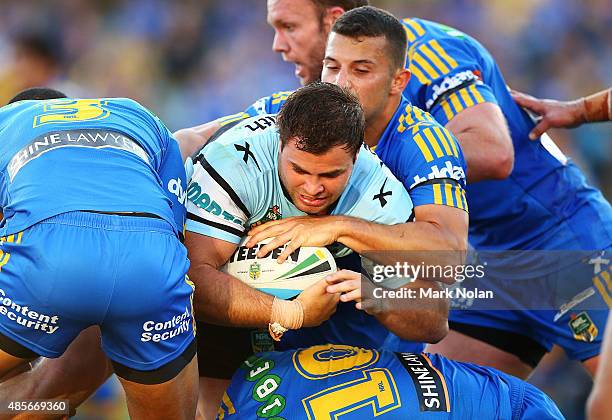 Wade Graham of the Sharks is tackled during the round 25 NRL match between the Parramatta Eels and the Cronulla Sharks at Pirtek Stadium on August...