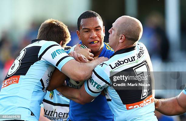 William Hopoate of the Eels is tackled during the round 25 NRL match between the Parramatta Eels and the Cronulla Sharks at Pirtek Stadium on August...