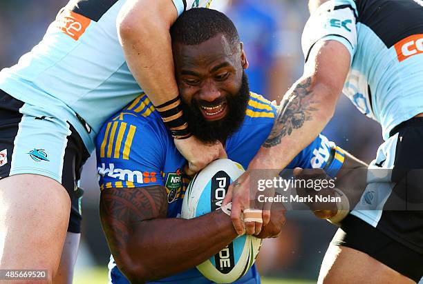 Semi Radradra of the Eels is tackled during the round 25 NRL match between the Parramatta Eels and the Cronulla Sharks at Pirtek Stadium on August...