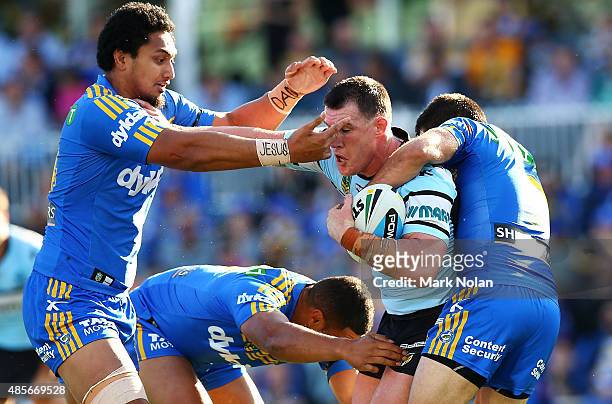 Paul Gallen of the Sharks is tackled during the round 25 NRL match between the Parramatta Eels and the Cronulla Sharks at Pirtek Stadium on August...