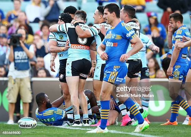 Sharks players celebrate a try by Michael Ennis during the round 25 NRL match between the Parramatta Eels and the Cronulla Sharks at Pirtek Stadium...