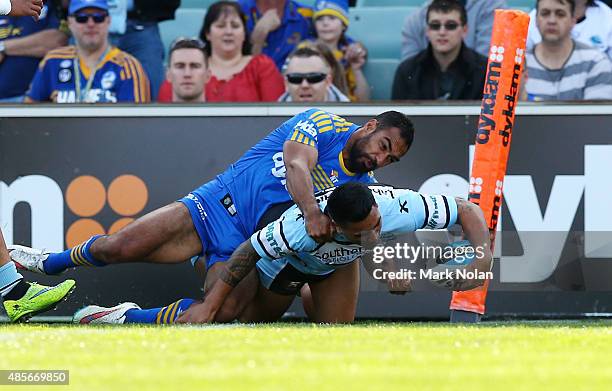 Sosaia Feki of the Sharks scores a try during the round 25 NRL match between the Parramatta Eels and the Cronulla Sharks at Pirtek Stadium on August...