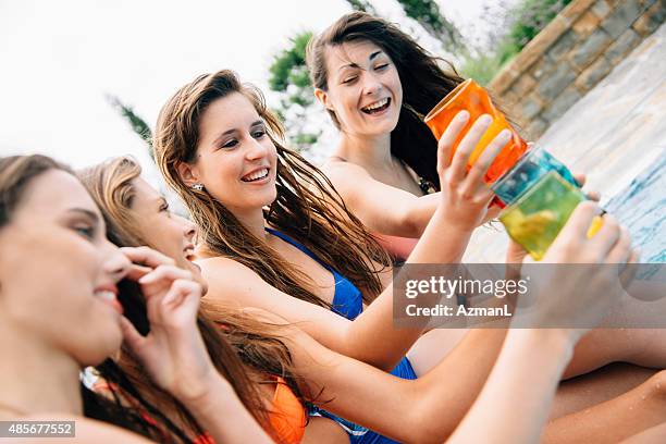 toasting by the pool - poolside gossip stock pictures, royalty-free photos & images