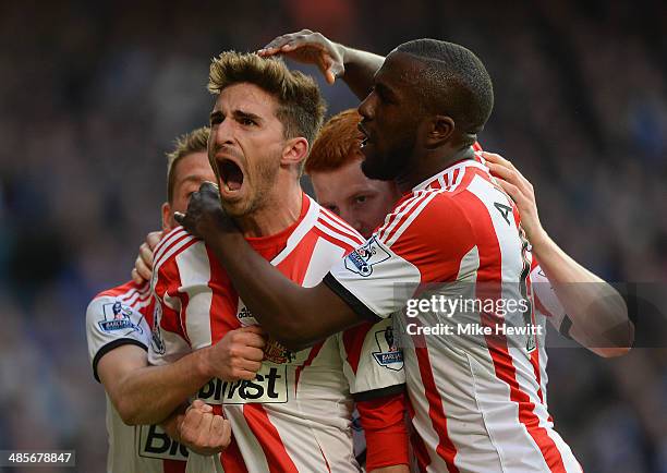 Fabio Borini of Sunderland is mobbed by team mates after scoring the winner from the penalty spot during the Barclays Premier League match between...