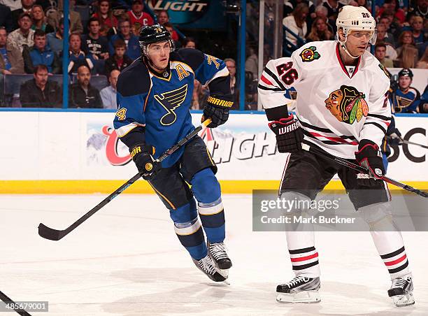 Oshie of the St. Louis Blues skates against Michal Handzus of the Chicago Blackhawks in Game Two of the First Round of the 2014 Stanley Cup Playoffs...