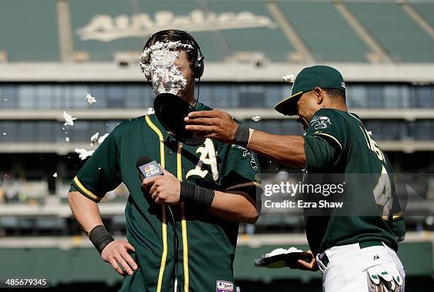 Coco Crisp covers Josh Reddick of the Oakland Athletics with a cream pie after Reddick had the game-winning hit in the ninth inning of their game...