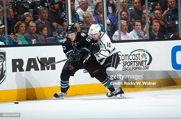 Tommy Wingels of the San Jose Sharks battles with Mike Richards of the Los Angeles Kings for the puck in Game One of the First Round of the 2014 NHL...