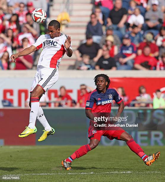Jerry Bengtson of the New England Revolution heads the ball away from Lovel Palmer of the Chicago Fire during an MLS match at Toyota Park on April19,...