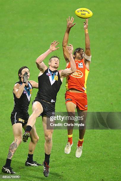 Tom Jonas of the Power and Jack Martin of the Suns compete for the mark during the round 22 AFL match between the Gold Coast Suns and the Port...