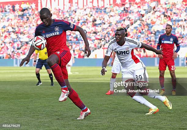 Bakary Soumare of the Chicago Fire controls the ball in front of Saer Sene of the New England Revolution during an MLS match at Toyota Park on...