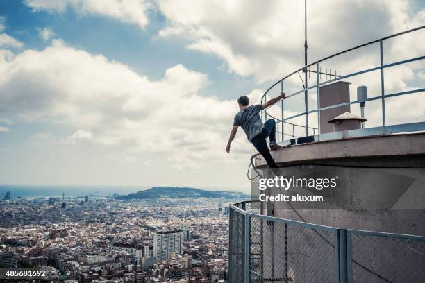 practicing parkour in the city - stuntman stockfoto's en -beelden