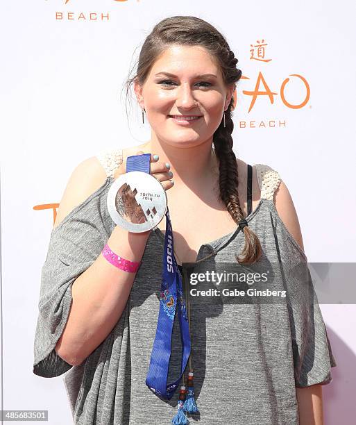 Olympic skier Devin Logan holds up her silver metal as she arrives at the grand opening of Tao Beach season at the Tao Beach at The Venetian Las...