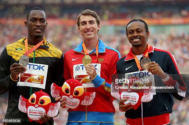 Silver medalist Hansle Parchment of Jamaica, gold medalist Sergey Shubenkov of Russia and bronze medalist Aries Merritt of the United States pose on...