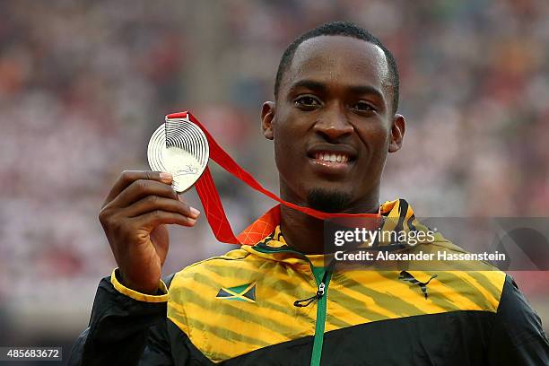 Silver medalist Hansle Parchment of Jamaica poses on the podium during the medal ceremony for the Men's 110 metres hurdles final during day eight of...