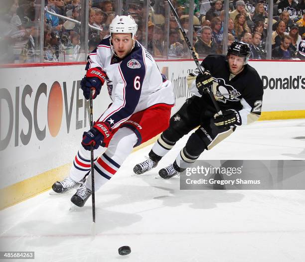 Nikita Nikitin of the Columbus Blue Jackets skates for the loose puck in front of Lee Stempniak of the Pittsburgh Penguins in Game Two of the First...