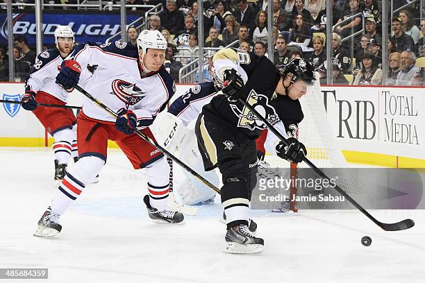 Nikita Nikitin of the Columbus Blue Jackets defends as Jussi Jokinen of the Pittsburgh Penguins controls the puck on the power play in the second...