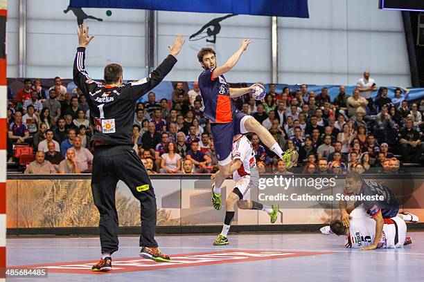 Marko Kopljar of PSG Handball is shooting the ball against Nandor Fazekas of MKB-MVM Veszprem during the game between PSG Handball and MKB-MVM...