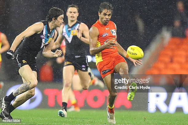 Jack Martin of the Suns kicks during the round 22 AFL match between the Gold Coast Suns and the Port Adelaide Power at Metricon Stadium on August 29,...