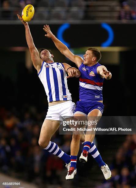 Todd Goldstein of the Kangaroos and Jack Redpath of the Bulldogs compete in a ruck contest during the 2015 AFL round 22 match between the North...