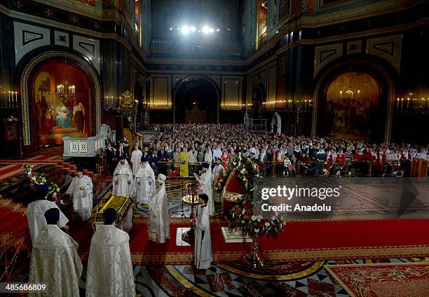 People attend the Easter Celebration ceremony led by Russian Orthodox Patriarch of Moscow and all Russia Kirill I, at Cathedral of Christ the...