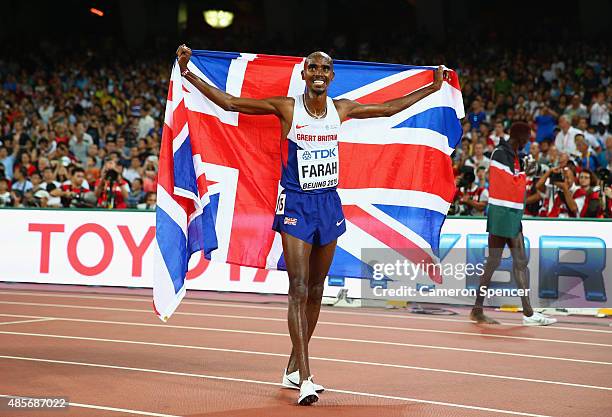 Mohamed Farah of Great Britain celebrates after crossing the finish line to win gold in the Men's 5000 metres final during day eight of the 15th IAAF...