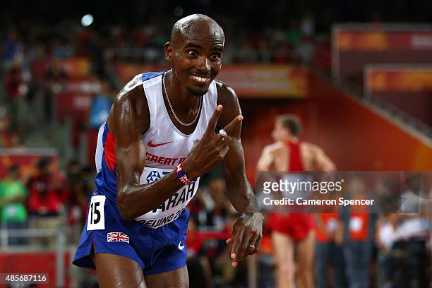 Mohamed Farah of Great Britain celebrates after crossing the finish line to win gold in the Men's 5000 metres final during day eight of the 15th IAAF...