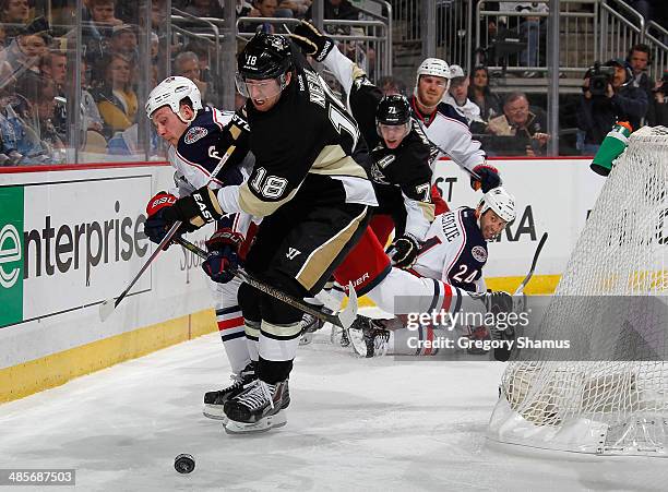 James Neal of the Pittsburgh Penguins battles for the loose puck against Nikita Nikitin of the Columbus Blue Jackets in Game Two of the First Round...