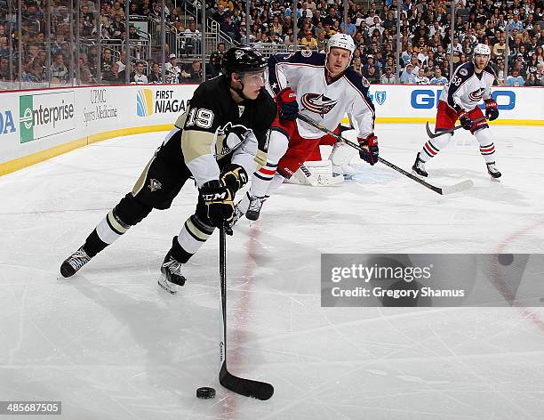 Beau Bennett of the Pittsburgh Penguins moves the puck in front of Nikita Nikitin of the Columbus Blue Jackets in Game Two of the First Round of the...