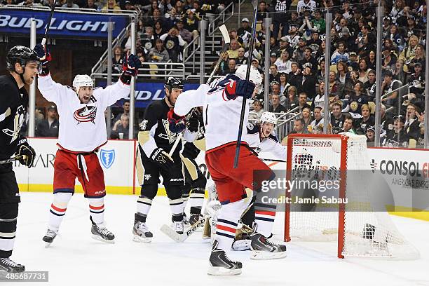 Brandon Dubinsky and Jack Johnson of the Columbus Blue Jackets celebrate Johnson's power play goal in the third period to send the game in to...