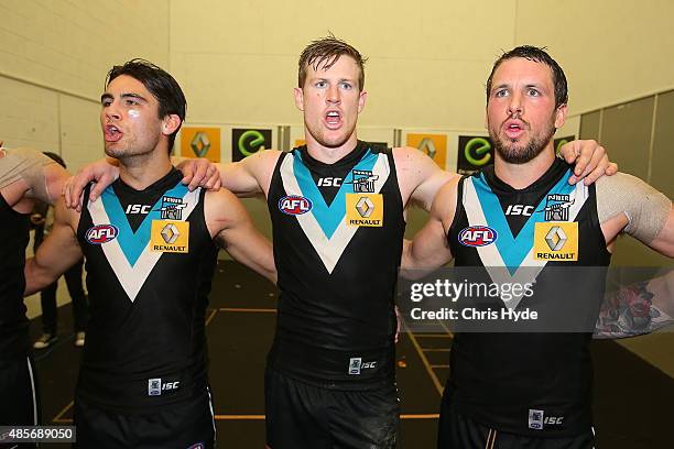 Power sing the team song after winning during the round 22 AFL match between the Gold Coast Suns and the Port Adelaide Power at Metricon Stadium on...