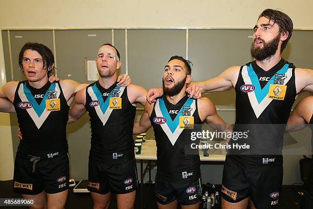 Power sing the team song after winning during the round 22 AFL match between the Gold Coast Suns and the Port Adelaide Power at Metricon Stadium on...