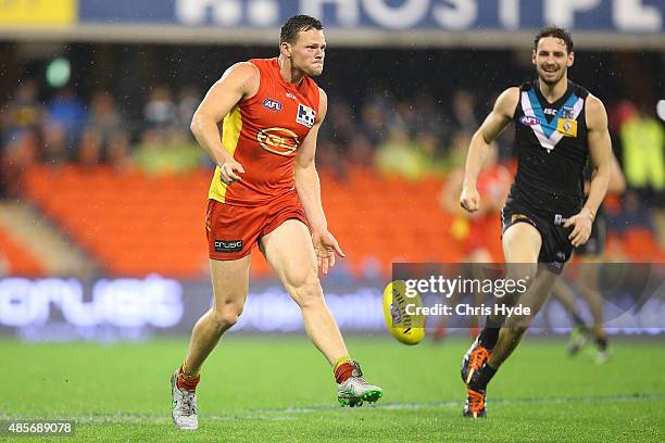 Steven May of the Suns kicks during the round 22 AFL match between the Gold Coast Suns and the Port Adelaide Power at Metricon Stadium on August 29,...