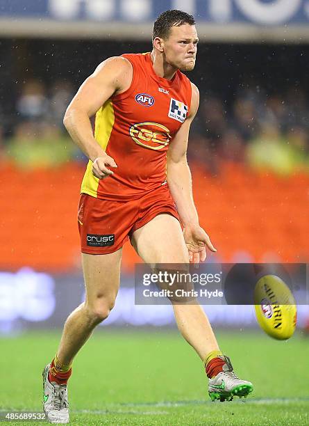 Steven May of the Suns kicks during the round 22 AFL match between the Gold Coast Suns and the Port Adelaide Power at Metricon Stadium on August 29,...