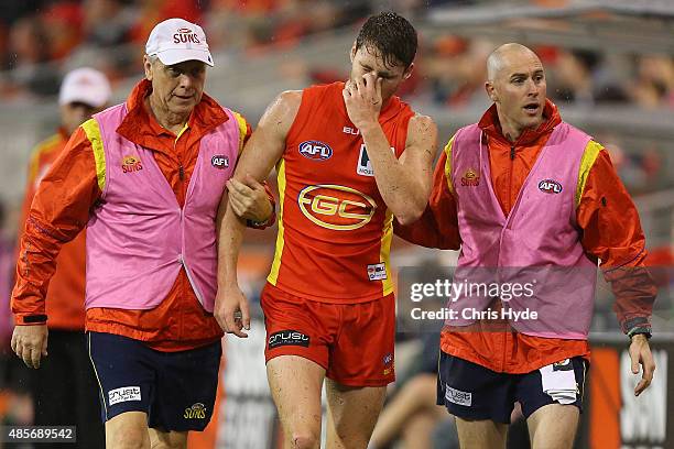 Clay Cameron of the Suns leaves the field injured during the round 22 AFL match between the Gold Coast Suns and the Port Adelaide Power at Metricon...