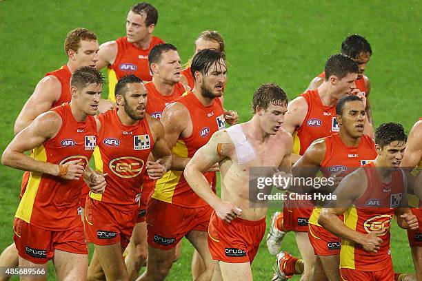 Suns leave the field at halftime during the round 22 AFL match between the Gold Coast Suns and the Port Adelaide Power at Metricon Stadium on August...