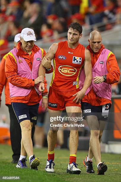 Clay Cameron of the Suns leaves the field injured during the round 22 AFL match between the Gold Coast Suns and the Port Adelaide Power at Metricon...